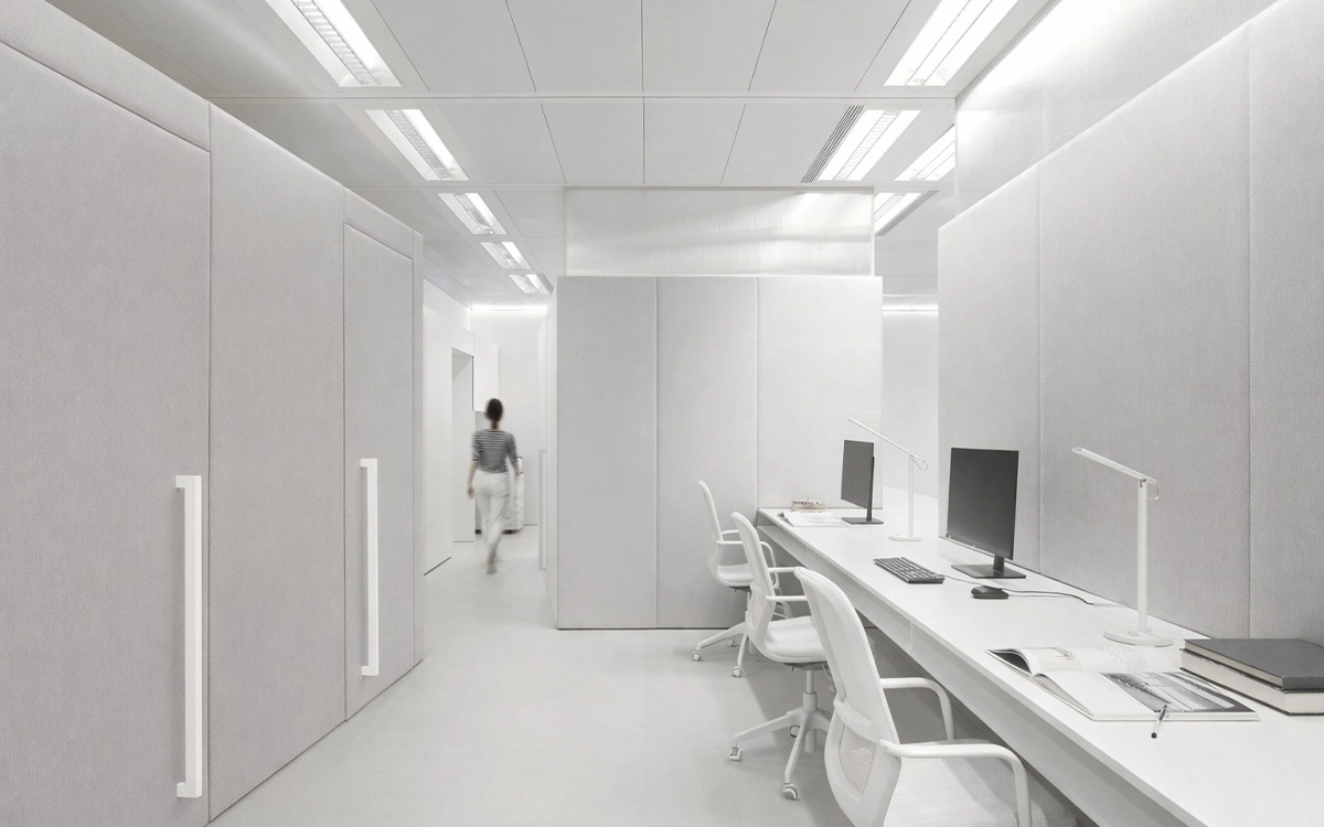 Góc làm việc trong văn phòng startup với tông trắng tối giản, nội thất liền mạch và cảm giác yên tĩnh, tập trung